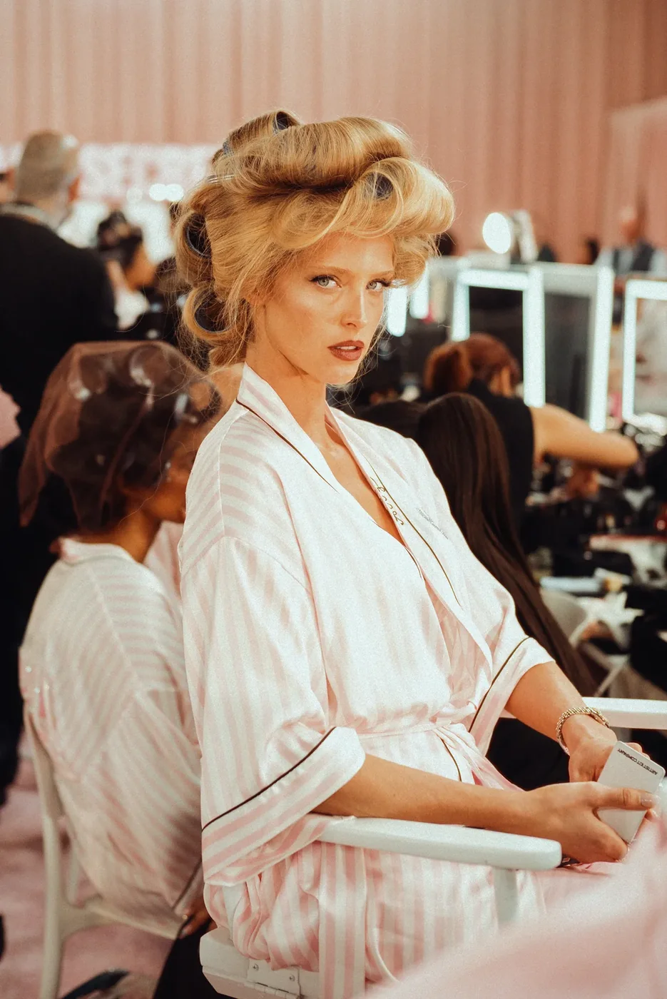 Large rollers setting volume through blonde hair