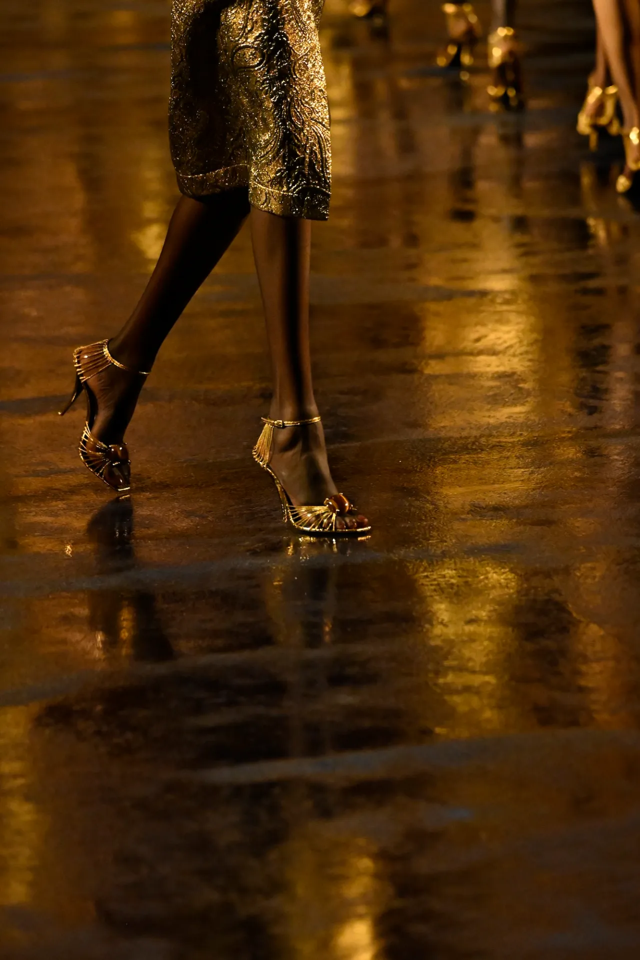 Saint Laurent: Jewelled gold sandals on the Spring Summer 2027 runway